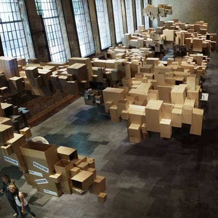 An exhibition featuring a giant pixelated cloud made of susp