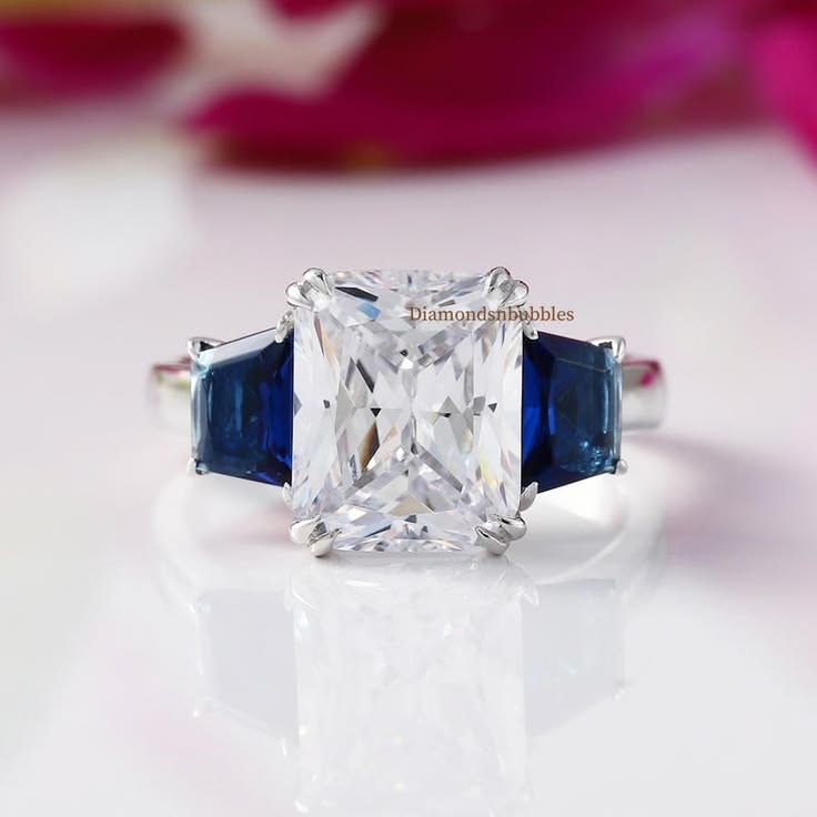 A striking three-stone engagement ring featuring a brilliant