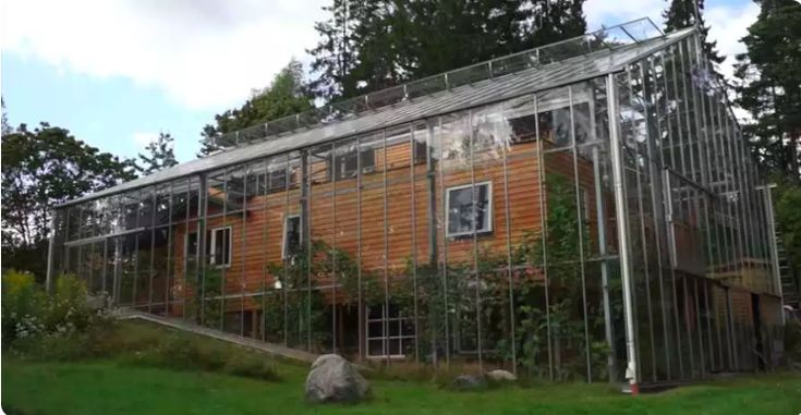 A Greenhouse Is Built Around The House To Warm It Naturally