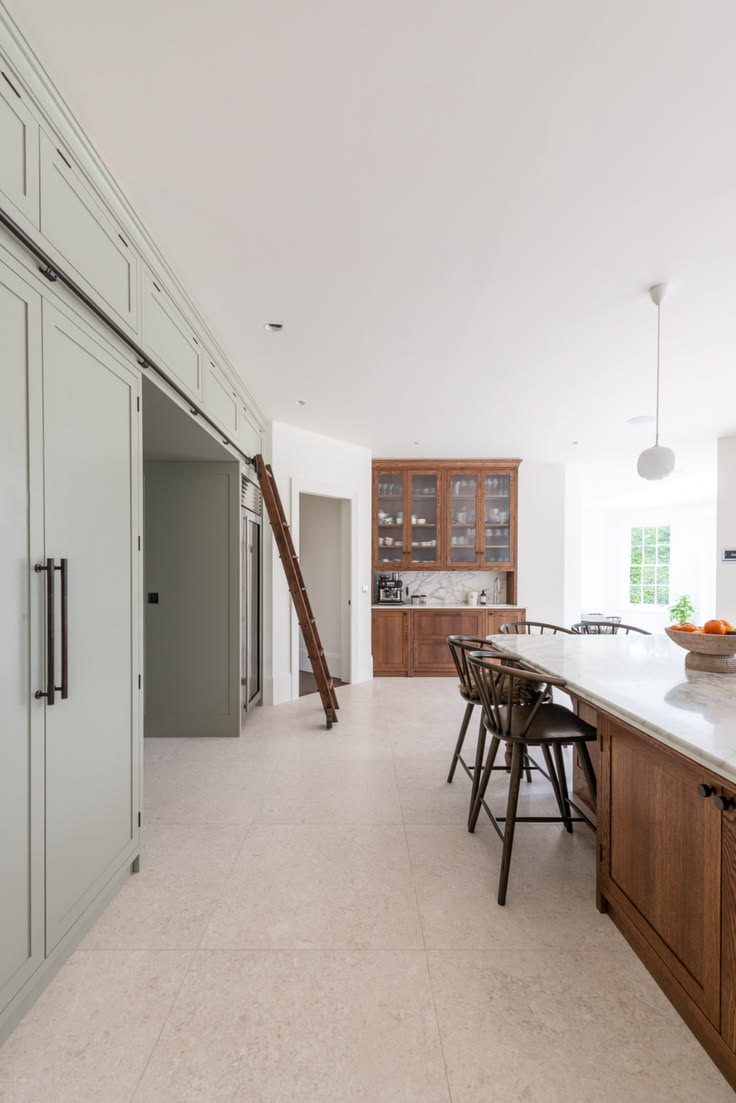 Ladder in the Surrey kitchen, with stained oak, marble and t