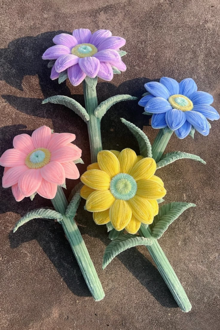 Colorful handmade pipe cleaner daisy flowers made with cheni