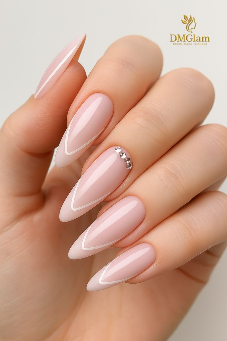 Almond nail design in nude tone with delicate white French l