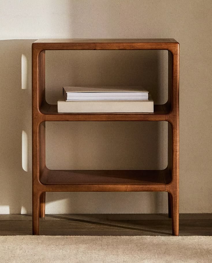 Chic, minimalist setup: dark wood shelf with books beside a 