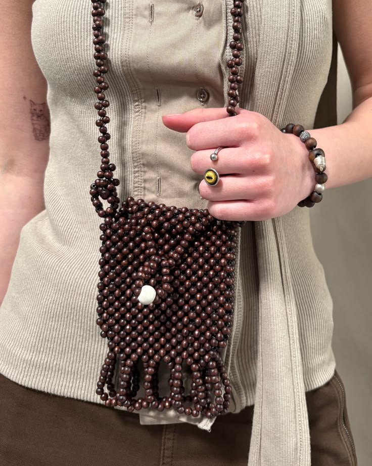 Kylie wears the LEMAIRE Sage tie top, with the Cacao asymmet
