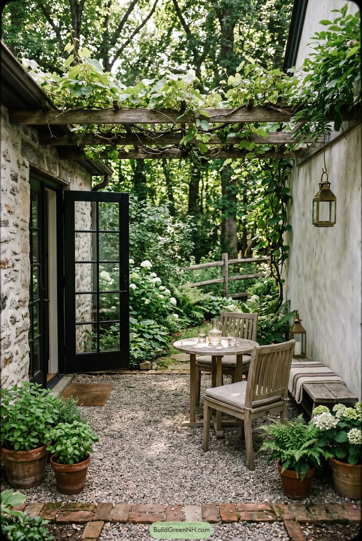 Narrow gravel patio with vine covered pergola. See our backy