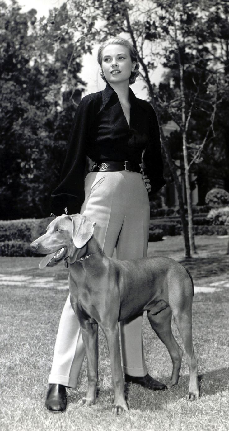 1956, American actress Grace Kelly pictured with her dog.