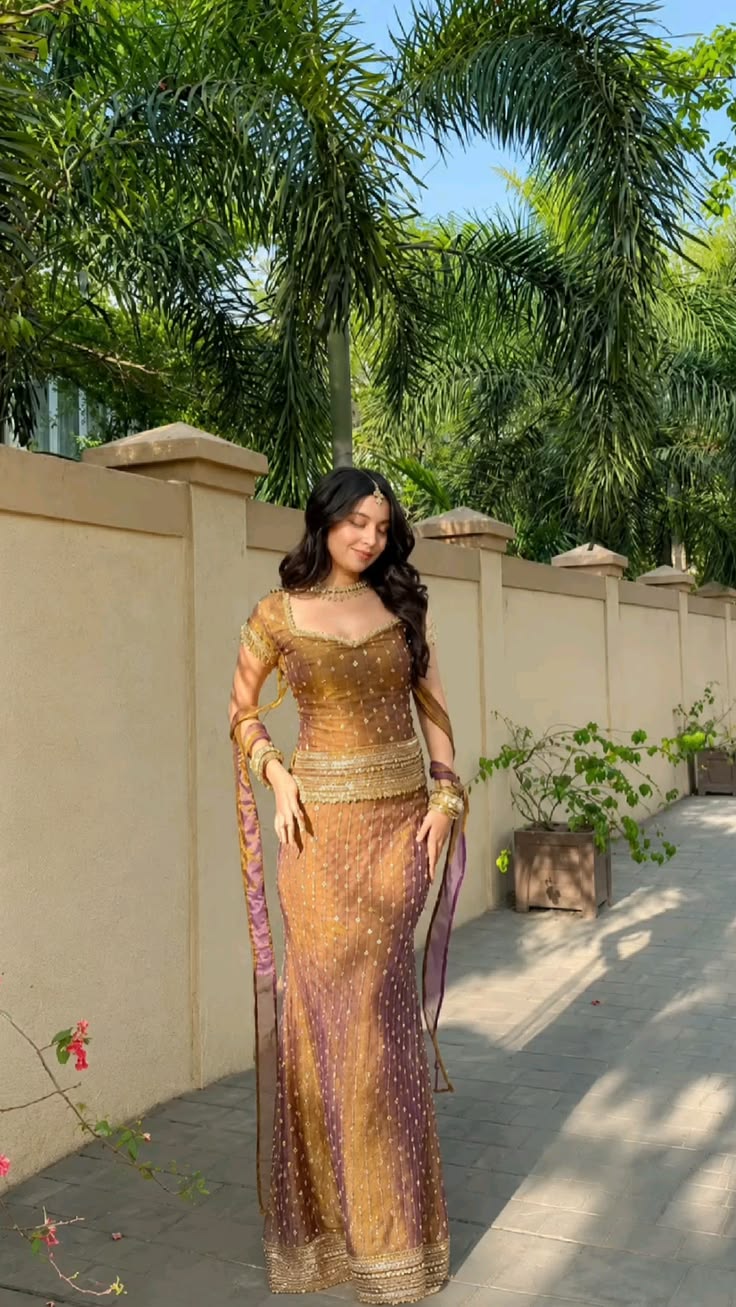 A dreamy golden and purple traditional outfit featuring intr
