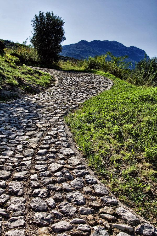 Cobblestone road. Winding cobblestone road going up to the m