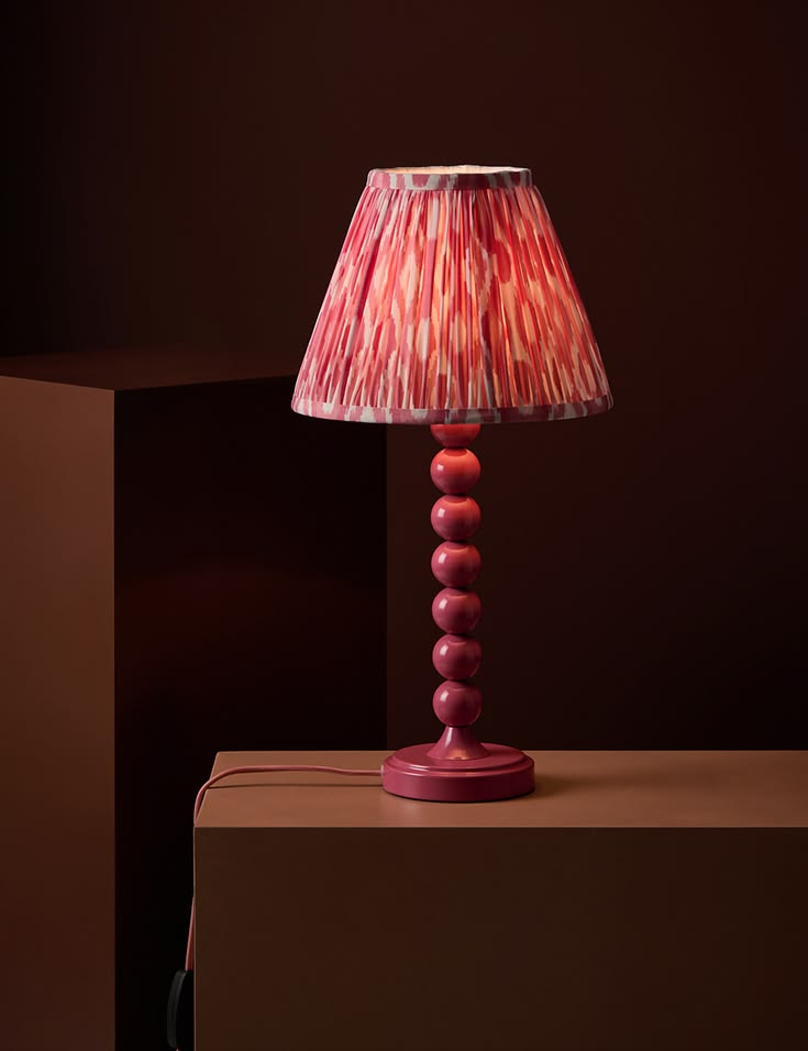 A painted bobbin lamp base in a Cherry red. It's coordinatin