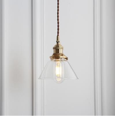 A glass ball pendant with a polished copper fitting, in a vi