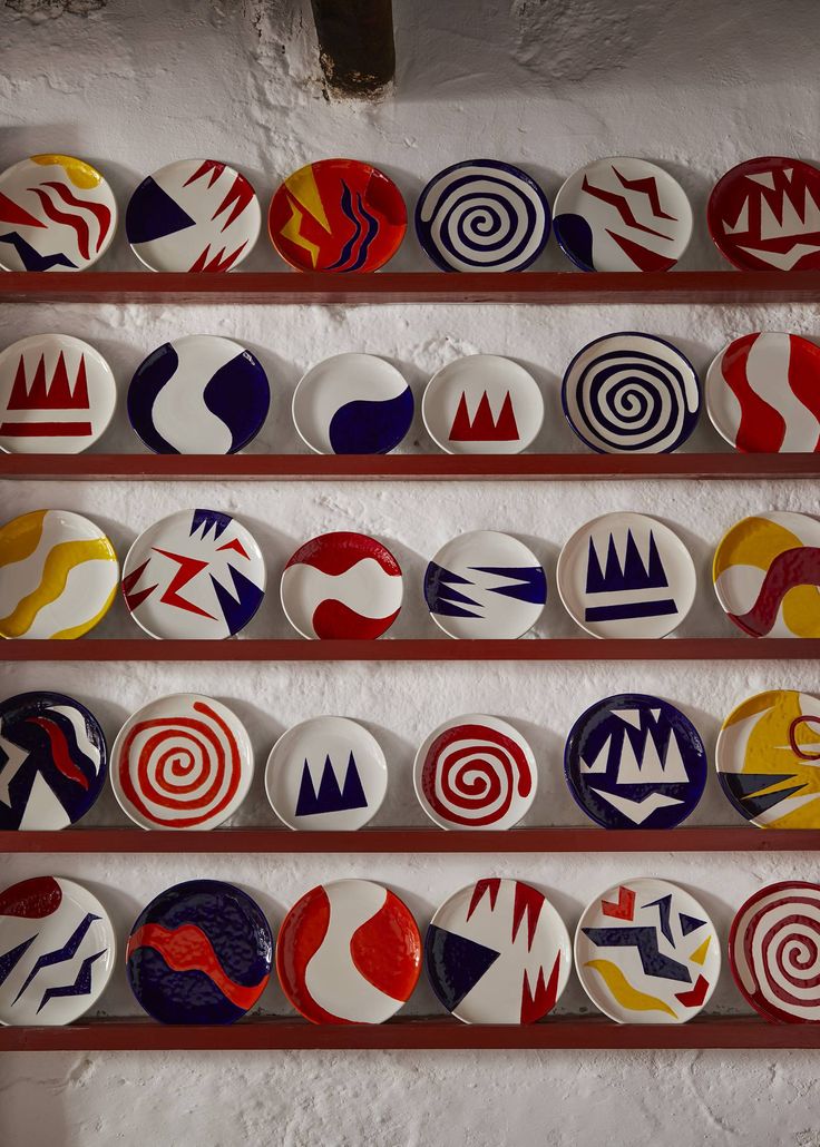 A plate rack displays a collection of Teddy Millington-Drake