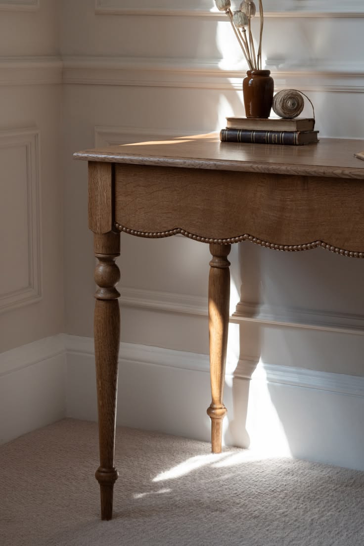 An elegant solid oak console table with softly shaped scallo