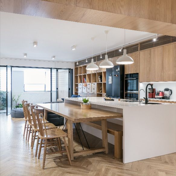 An open kitchen and custom island, plus long dining table fo