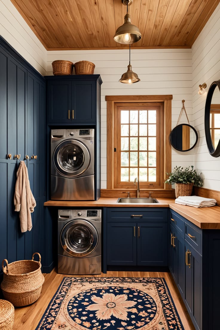 This cozy farmhouse laundry room blends navy blue cabinetry,