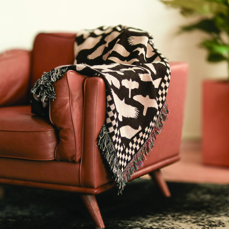Wrap yourself in our 'Hawks in Flight' woven blanket, where 