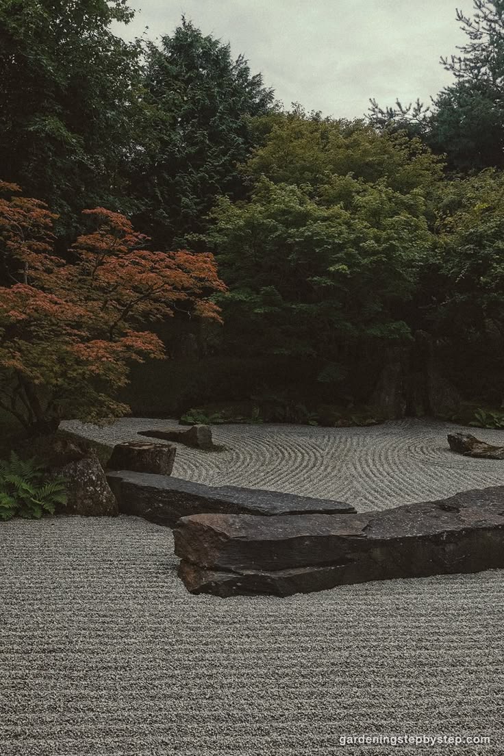 Raked gravel around set stone works in a small front garden 