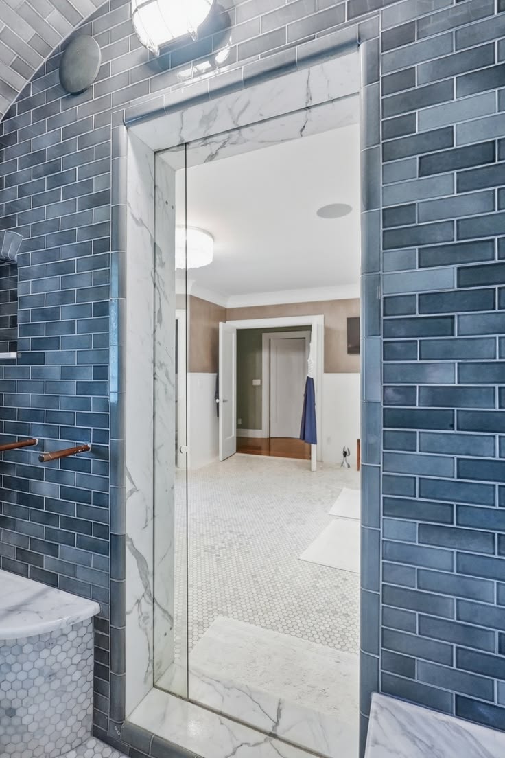 This calming blue-tile shower pairs beautifully with AIRMADA