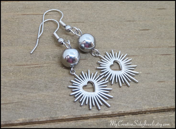 Stainless steel sunburst heart earrings.  #silverearrings #h