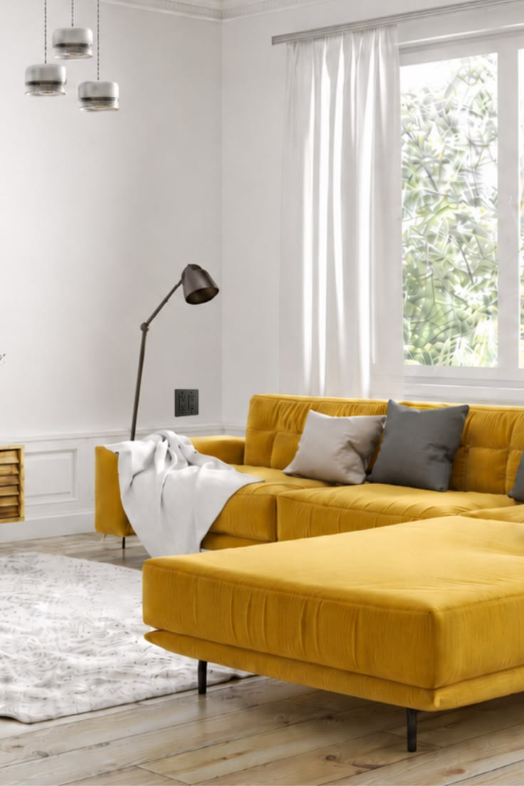 A bright living room with white walls, warm wood flooring, a