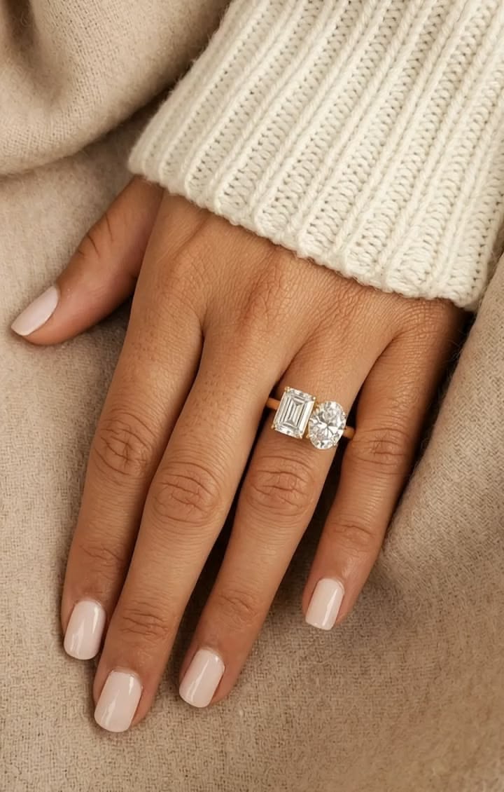 Discover the timeless beauty of an Emerald & Oval Two Stone 