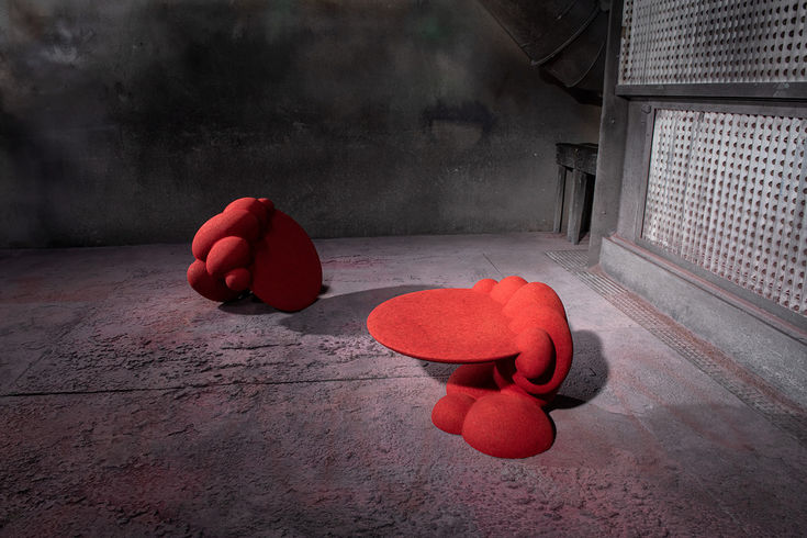This asymmetrical side table is supported on one side by irr