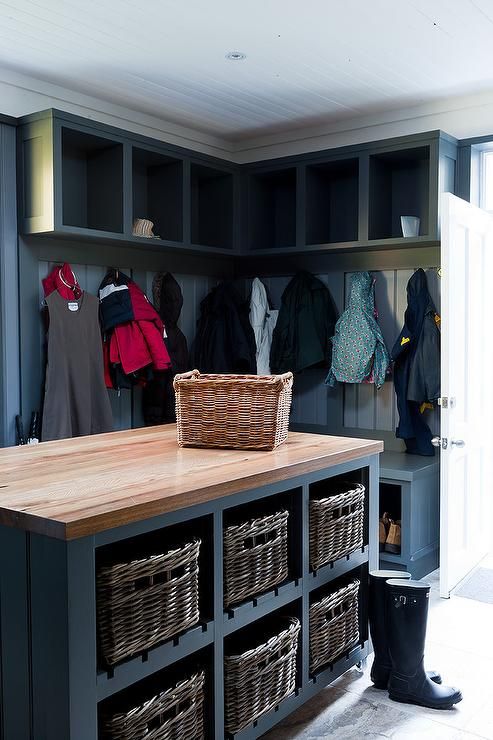 Large blue mudroom is equipped with a blue island fitted wit