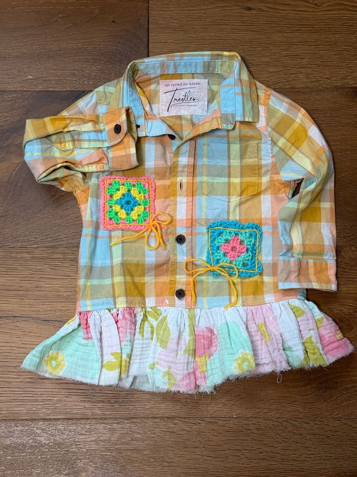 Introducing our 2T Ruffled Crochet Plaid Shirt! This sweet p