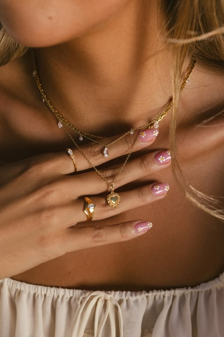 A layered gold necklace stack brings effortless elegance to 