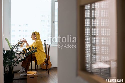 young woman in stylish yellow shirt and yellow dreads shotti