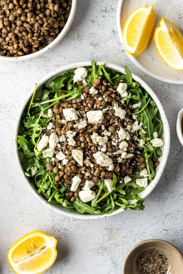 Overhead of a bowl of arugula salad with green lentils and f