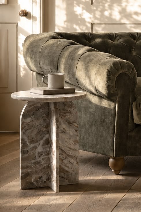 A beautiful marble side table brings sculptural character to