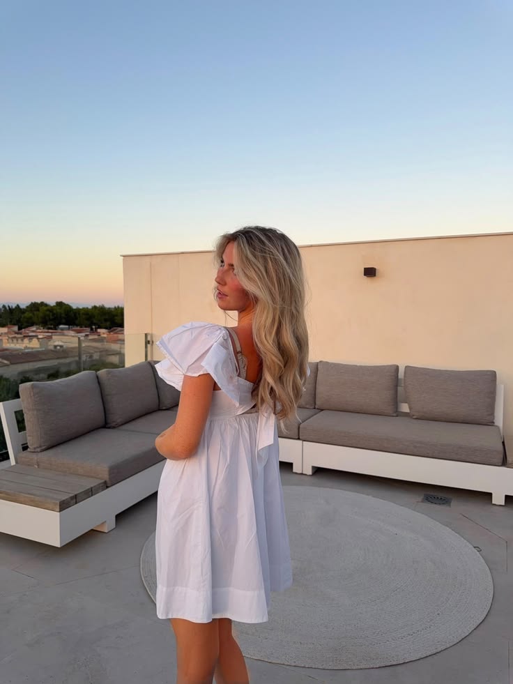 Soft golden-hour light, a romantic white mini dress and effo