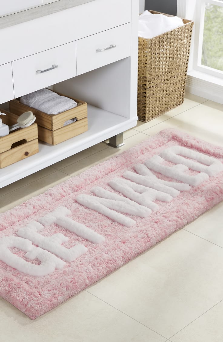 This fun statement bath ruf features the phrase 'Get Naked' 