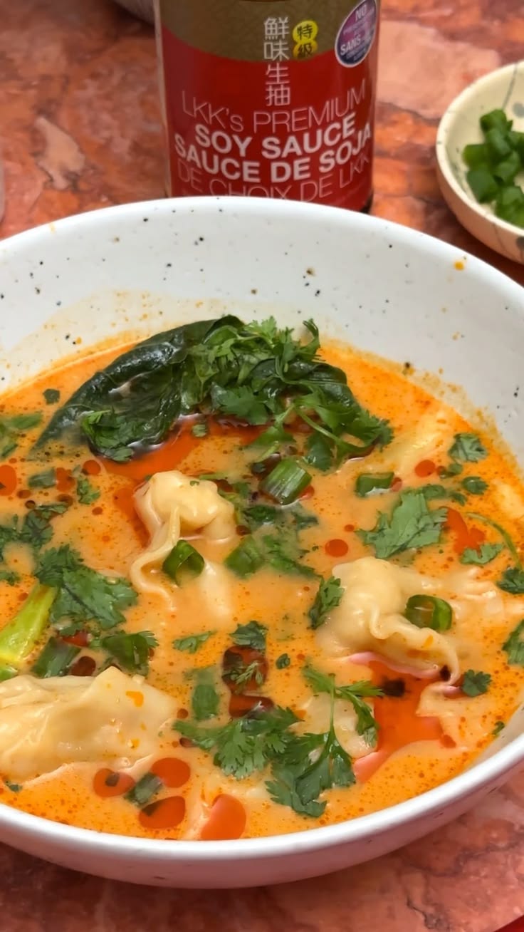 A cozy red curry wonton soup made with tender wontons in a r