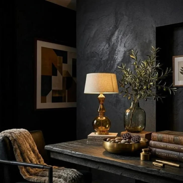 Rich brown glass and warm metallic details make this table l