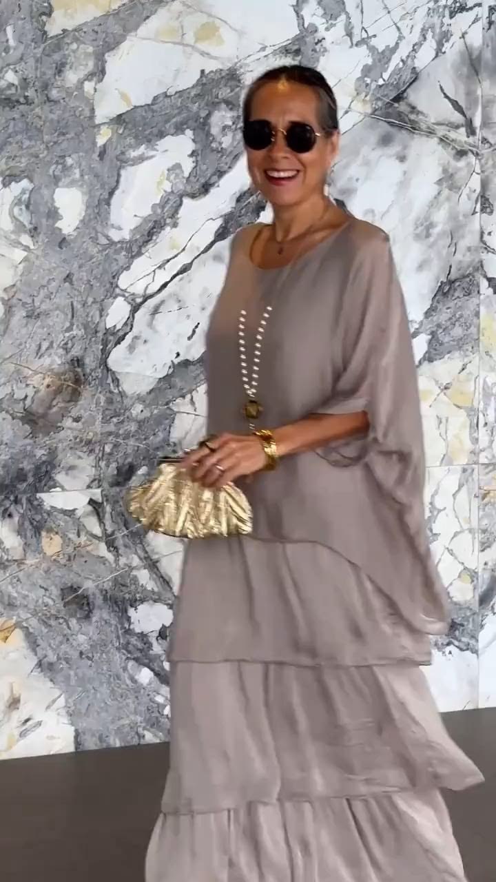 This dress features a sleek black chiffon base that exudes q