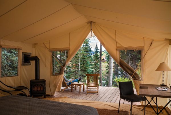 A camp tent before a cabin?