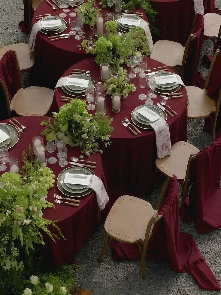Burgundy wedding table decor with elegant floral arrangement