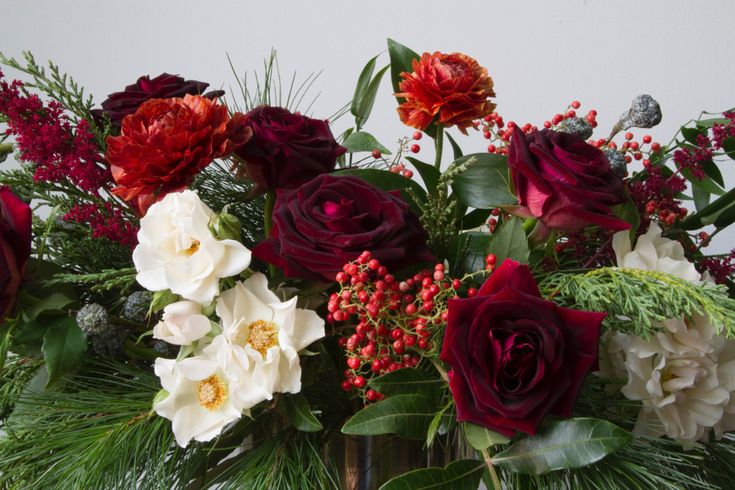 Christmas centerpiece by aster & fir. Black beauty roses, ra
