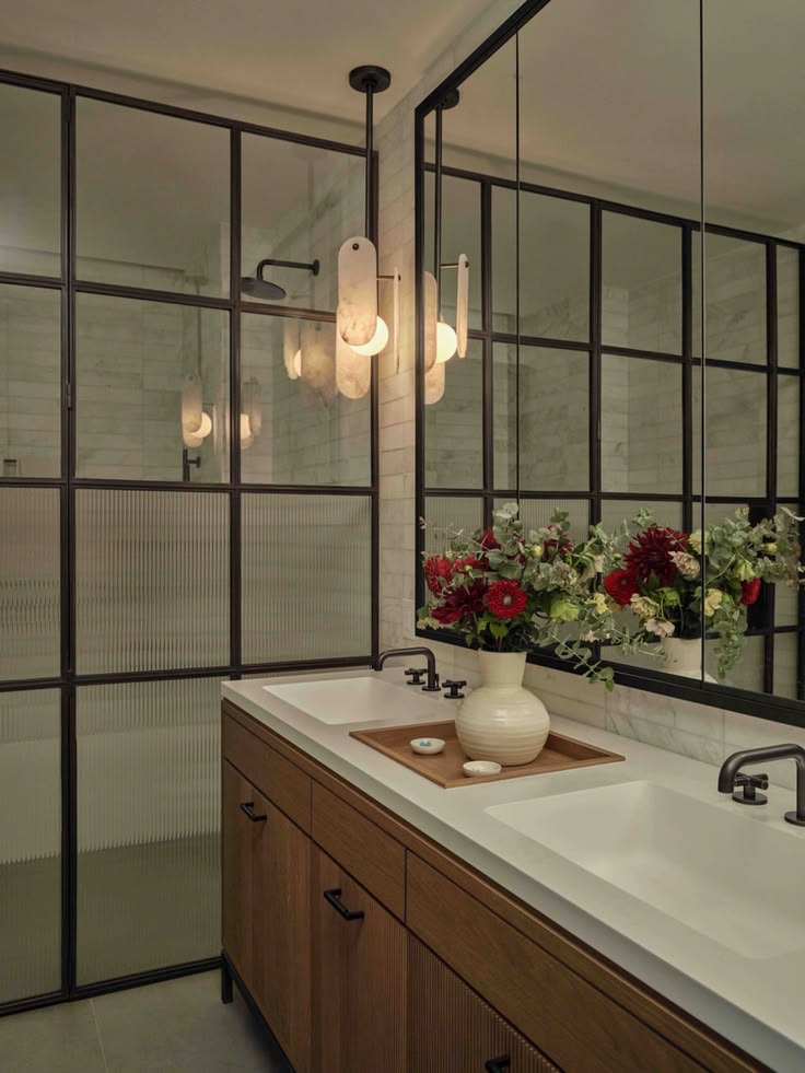 Modern bathroom featuring a double sink, wooden cabinetry, d