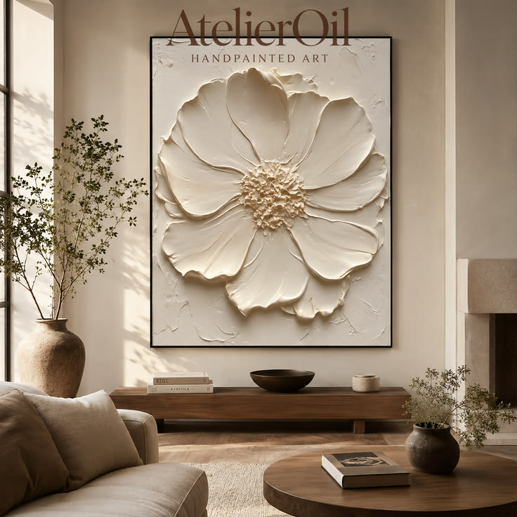 A sculptural white flower rises from a softly textured surfa