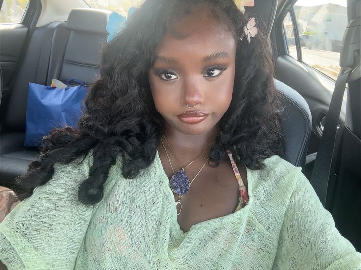 Black girl soft glam makeup on dark skin with long curly hai