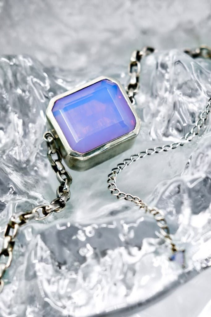 Design Notes iridescent periwinkle glass is suspended by a h