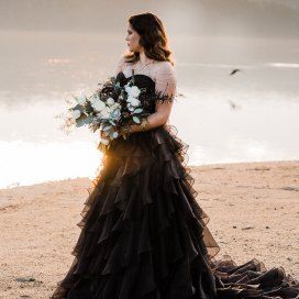 Winter wedding by the lake with a stunning black dress and a