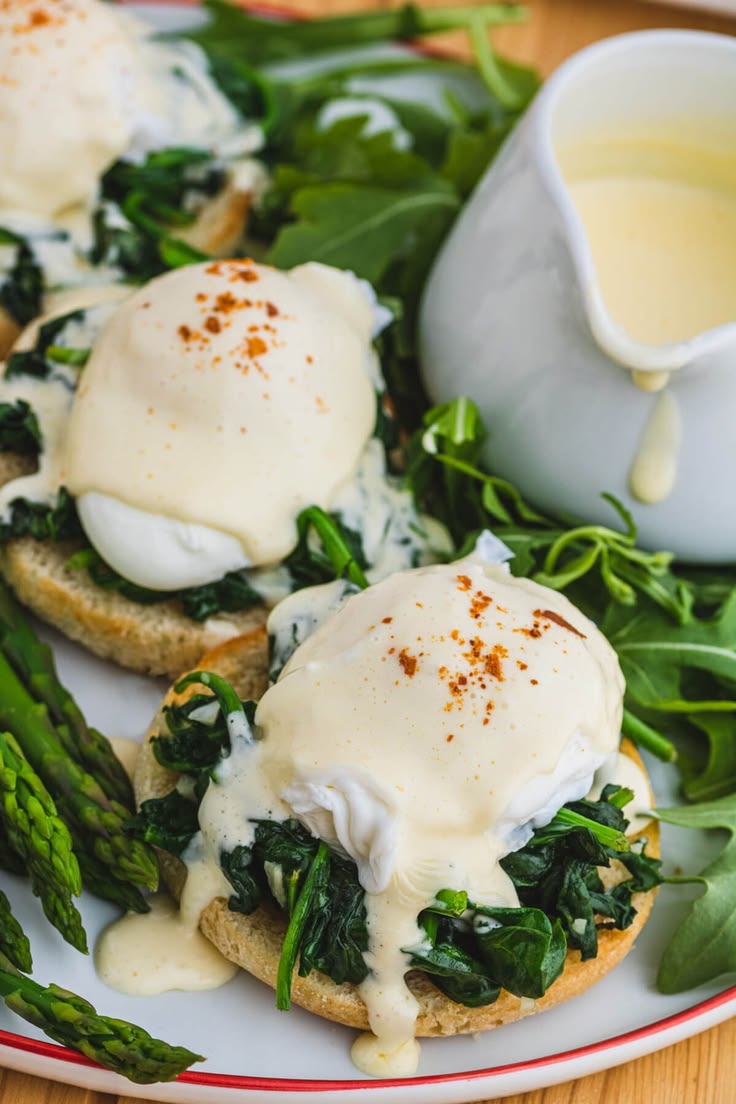 A red rimmed white plate holding two poached eggs covered in