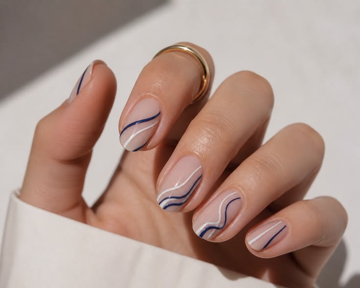 A minimalist black-and-white manicure built on a sheer nude 