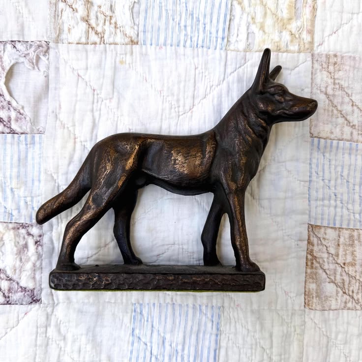 A well-modeled cast iron German Shepherd doorstop with a ric