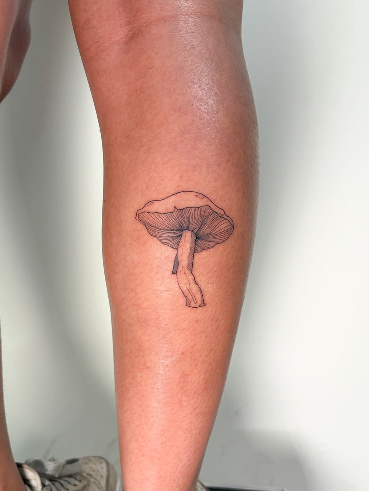 Minimalist mushroom tattoo featuring delicate fine line shad