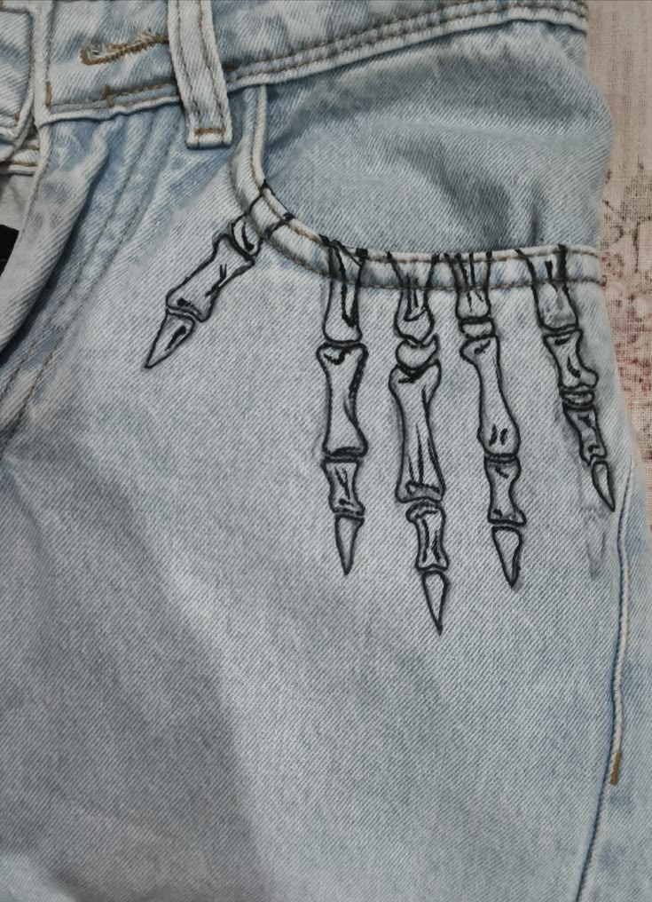 Hand-painted skeleton finger design on light wash denim 🖤 Mi