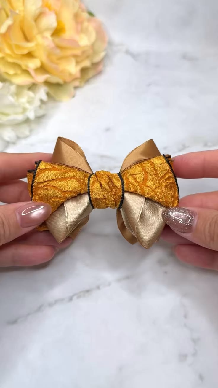 Warm gold satin is paired with a textured metallic ribbon ed